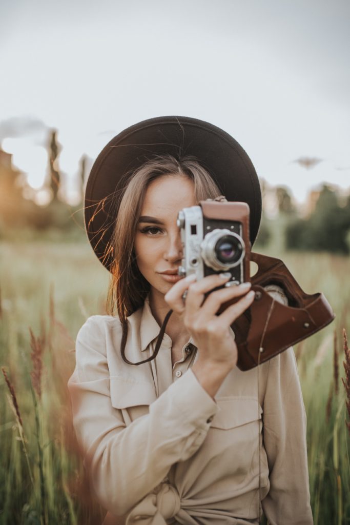 girl with camera taking photos